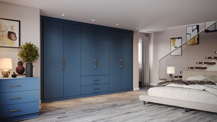 Modern blue fitted wardrobe with doors open